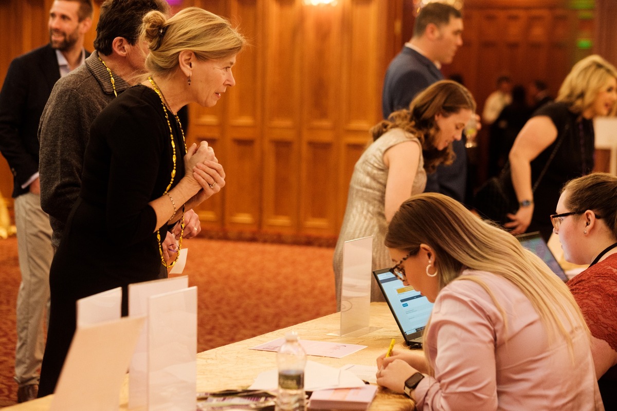 woman checking in to event